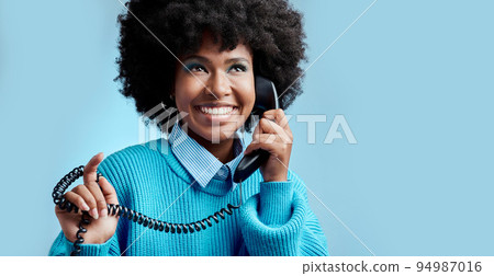 Telecom landline, phone or black woman talking, communication on blue mockup studio background. Happy, smile or young African girl model speaking to contact on vintage phone with mock up space Telecom landline, phone or black woman talking, communication on blue mockup studio background. Happy, smile or young African girl model speaking to contact on vintage phone with mock up space 94987016