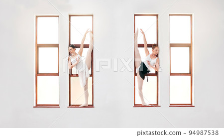 Ballet, art and dancers dancing on the window at the dance academy in a practice studio. Elegant team of ballerinas stretching, training and practicing a skill for classical recital performance. 94987538