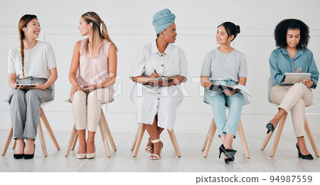 Diversity, interview and business people in waiting room at a job, hiring or recruitment center. Corporate, women and professionals talking with technology in a unemployment office for a work vacancy 94987559
