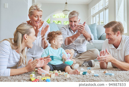 Family, clapping hands and baby playing with toys while sitting on the living room floor. Love, care and happy people cheering for child development, learning and growth while bonding in the lounge. Family, clapping hands and baby playing with toys while sitting on the living room floor. Love, care and happy people cheering for child development, learning and growth while bonding in the lounge. 94987833