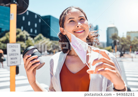 Business woman take off mask at end of covid with a happy smile in the city with a cup of coffee. Pandemic regulations safety update or social distancing change in public and business environment Business woman take off mask at end of covid with a happy smile in the city with a cup of coffee. Pandemic regulations safety update or social distancing change in public and business environment 94988281