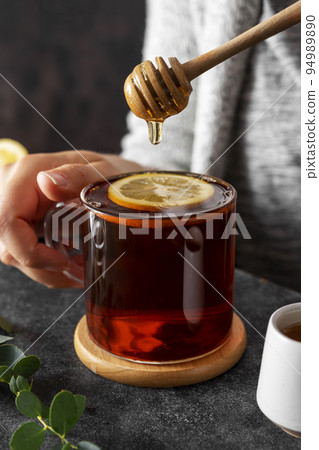 Black tea in glass cup, morning hot drink with lemon and honey. 94989890