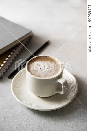 Coffee cup with milk in white ceramic cup. Lifestyle morning drink photo 94989901