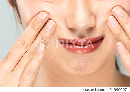 woman doing facial massage woman doing facial massage 94990067