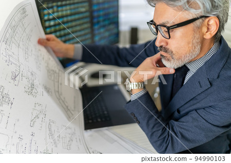 Construction supervisor confirming construction drawings First-class architect Gray hair Beard Construction supervisor confirming construction drawings First-class architect Gray hair Beard 94990103