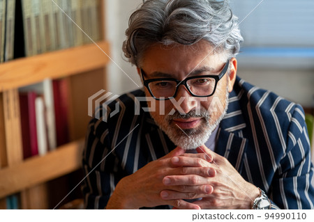 Cool business man British gentleman elegant appearance study room waiting on customers sitting 94990110