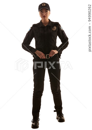 Full length shot of a redheaded female police officer posing for the camera isolated on white background. Full length shot of a redheaded female police officer posing for the camera isolated on white background. 94990262