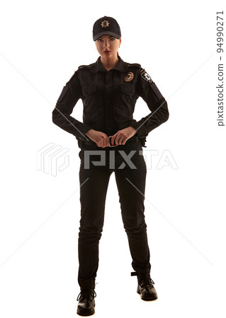 Full length shot of a redheaded female police officer posing for the camera isolated on white background. Full length shot of a redheaded female police officer posing for the camera isolated on white background. 94990271