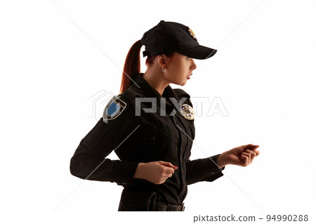 Close-up shot of a redheaded female police officer posing for the camera isolated on white background. Close-up shot of a redheaded female police officer posing for the camera isolated on white background. 94990288