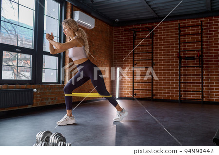 Woman training with fitness rubber band Woman training with fitness rubber band 94990442