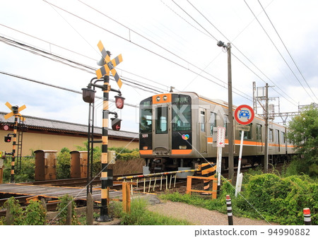 A train passing through a railroad crossing in the Nara Heijo Palace Ruins A train passing through a railroad crossing in the Nara Heijo Palace Ruins 94990882
