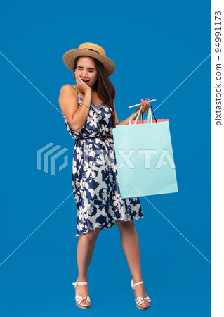 Portrait of unhappy young woman looking in her wallet in shopping center, spent too much, not enough cash, lost money, broke 94991173