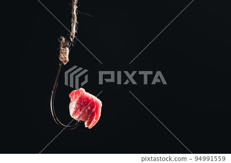 A piece of meat on a fishing hook. Meat bait. Get hooked. Fishing bait. Fishing hook. A piece of meat on a fishing hook. Meat bait. Get hooked. Fishing bait. Fishing hook. 94991559