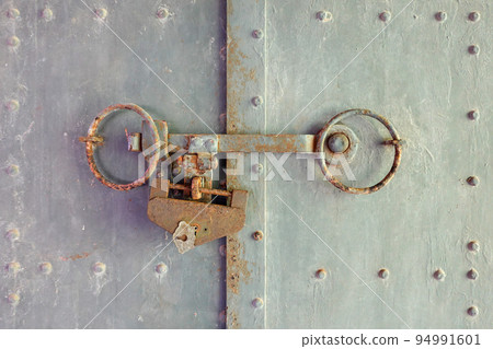 Retro lock and iron door of red brick warehouse 94991601