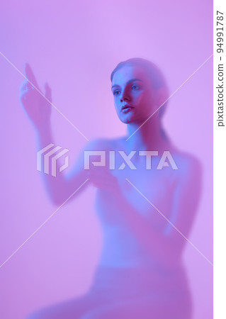 Frozen. Silhouette of young girl immersed in clouds of smoke, fog on pink neon background with backlight diffuser. Art, creativity, futurism Frozen. Silhouette of young girl immersed in clouds of smoke, fog on pink neon background with backlight diffuser. Art, creativity, futurism 94991787