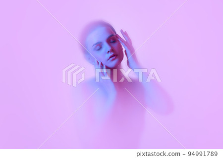 Mystical portrait of young tender girl immersed in clouds of smoke, fog on pink neon background with backlight diffuser. Art, creativity, futurism 94991789