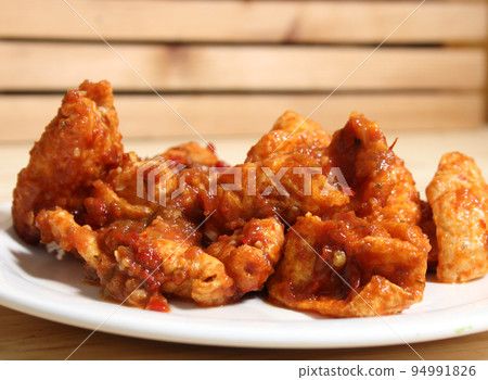 Fried Pork Skins With Red Salsa in Rustic Kitchen 94991826