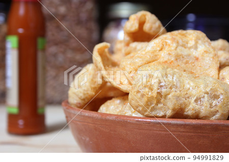 Fried Pork Skins With Hot Sauce in Rustic Kitchen Fried Pork Skins With Hot Sauce in Rustic Kitchen 94991829