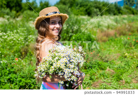 Small girl collecting flowers and herbs on sunny day, vacation concept Small girl collecting flowers and herbs on sunny day, vacation concept 94991833
