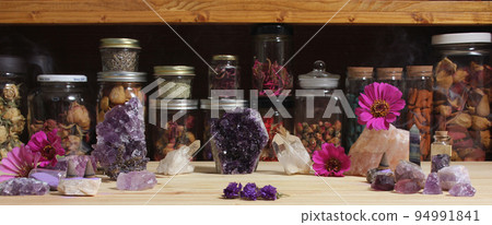 Amethyst Crystals and Flowers On Meditation Table Amethyst Crystals and Flowers On Meditation Table 94991841