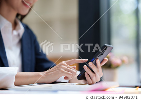 A businesswoman completes KYC using an online banking program in order to open a digital savings account. The definition of cyber security 94992071