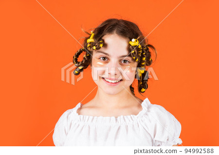 How to choose Papillote. eye therapy patch. beauty and fashion. small girl has hair curlers papillotes. kid hairdresser salon. healthy long hairstyle. hair care for child. little kid with hair roller 94992588