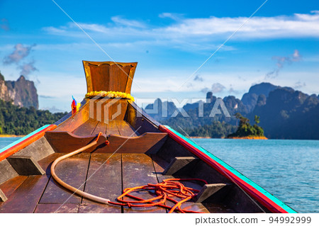 Long Tail boat on Khao Sok national park Cheow Lan Dam lake in Surat Thani, Thailand Long Tail boat on Khao Sok national park Cheow Lan Dam lake in Surat Thani, Thailand 94992999