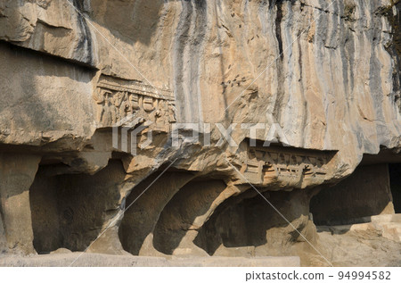 Carving details on the outer side of the Tulja Leni (cave), it is the smallest group of caves with 11 caves datable from 1st century B.C. to 1st century A.D. Junnar, near Pune, Maharashtra, India 94994582
