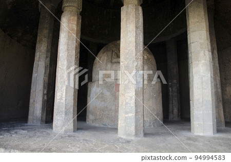 Stupa at the Tulja Leni (cave) with a round room, twelve octagonal pillars encircle the stupa, with a wonderfully carved domed ceiling above, Junnar, near Pune, Maharashtra, India 94994583