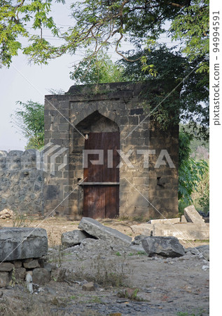 Old gate near Habashi Mahal, also know as Malik Ambar Palace, it was built around 1590, it is located in Junnar, near Pune, Maharashtra, India Old gate near Habashi Mahal, also know as Malik Ambar Palace, it was built around 1590, it is located in Junnar, near Pune, Maharashtra, India 94994591