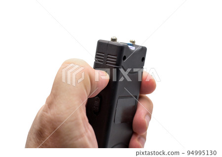 Taser in a man's hand, close-up, isolated on a white background 94995130