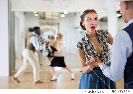 Woman and man dancing swing in studio 94995249
