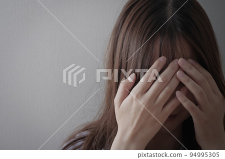 Painful young woman holding her head Painful young woman holding her head 94995305