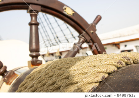 Ship's steering wheel on the old retro battleship 94997632