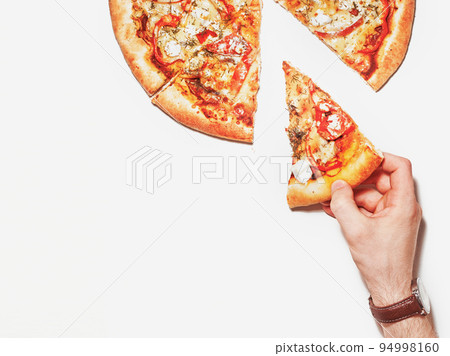 Slice of pizza in hand isolated on white. Top view Slice of pizza in hand isolated on white. Top view 94998160