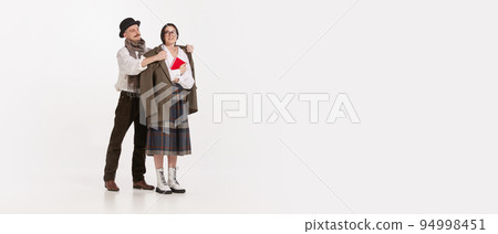 Portrait of stylish man, gentlemen putting coat on woman's shoulder. Feeling warm. Romantic 94998451