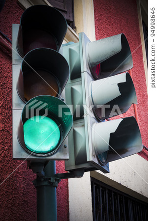 Green go light on traffic light on street corner Green go light on traffic light on street corner 94998646