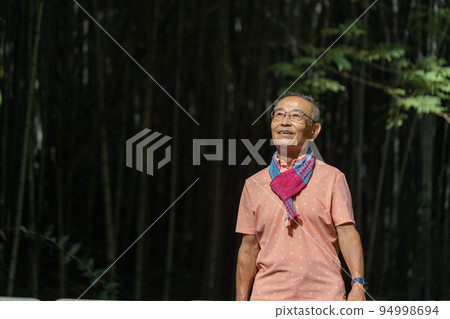 Cheerful and lively senior man doing his hobby walking with a smile Cheerful and lively senior man doing his hobby walking with a smile 94998694