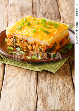 Escondidinho de frango Brazilian chicken shepherd's pie is a homey, comforting one dish wonder or casserole closeup in the plate. Vertical Escondidinho de frango Brazilian chicken shepherd's pie is a homey, comforting one dish wonder or casserole closeup in the plate. Vertical 94999304