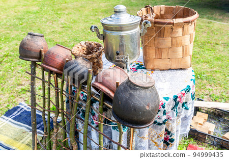 Vintage wicker handmade basket and utensils of pottery Vintage wicker handmade basket and utensils of pottery 94999435