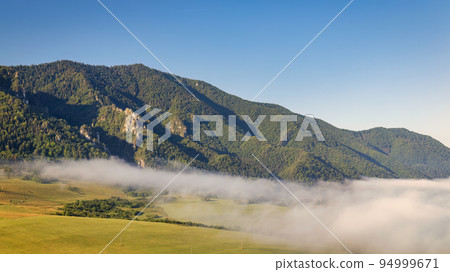 Misty mountain landscape in a summer morning. Misty mountain landscape in a summer morning. 94999671