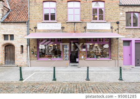 Damme, Flemish Region - Belgium - Facade in brickstone and bright colors of a vintage restaurant and souvenir shop Damme, Flemish Region - Belgium - Facade in brickstone and bright colors of a vintage restaurant and souvenir shop 95001285