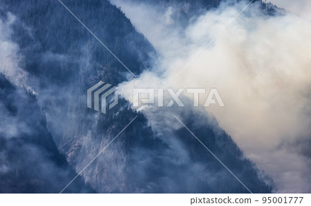 BC Forest Fire and Smoke over the mountain near Hope during a hot sunny summer day. BC Forest Fire and Smoke over the mountain near Hope during a hot sunny summer day. 95001777