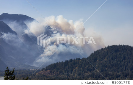 BC Forest Fire and Smoke over the mountain near Hope during a hot sunny summer day. BC Forest Fire and Smoke over the mountain near Hope during a hot sunny summer day. 95001778
