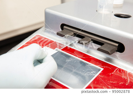 Scientist preparing microscope slides with liquid based cytology method for pap smear test. Cervical cancer concept. Medical concept. Scientist preparing microscope slides with liquid based cytology method for pap smear test. Cervical cancer concept. Medical concept. 95002878