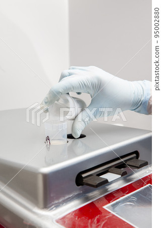 Scientist preparing microscope slides with liquid based cytology method for pap smear test. Cervical cancer concept. Medical concept. 95002880