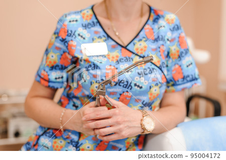 Anoscopes with ring lights in the hands of a doctor. Reusable Proctology Instruments 95004172