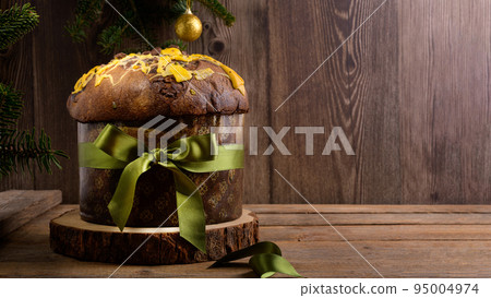 Traditional Italian Christmas Cake Panettone with green bow on wooden rustic background, copy space Traditional Italian Christmas Cake Panettone with green bow on wooden rustic background, copy space 95004974