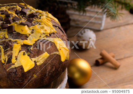 Traditional Italian Christmas Cake Panettone and festive decoration on wooden rustic background, close up 95004975