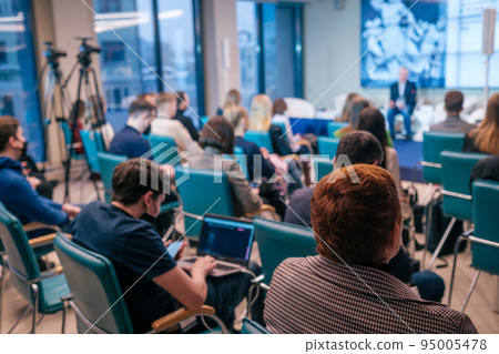 Businesspeople watching presentation in evening Businesspeople watching presentation in evening 95005478